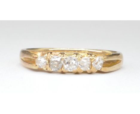 An 18ct gold five stone diamond ring set with five round cut graduating diamonds. Diamonds estimated 20 pts. Marked 18ct to t