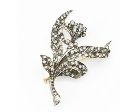 An 18ct antique gold, silver and diamond floral brooch pin. The brooch in the form of a floral spray set with rose and old cu