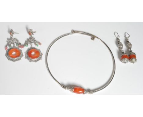 A group of silver white metal jewellery set with red hard stones to include a pair of Chinese filigree earrings set with red 