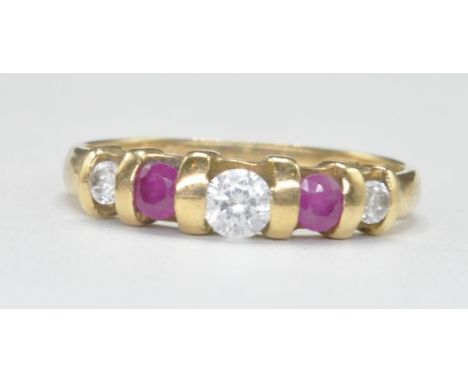 A stamped 750 18ct gold ring set with three round cut white stones and alternate round cut pink stones. Marked 750 to the ban