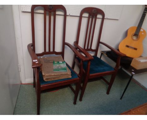 Pr. Of Curved top Oak Elbow chairs with stick backs, applied floral roundels and drop in upholstered seats