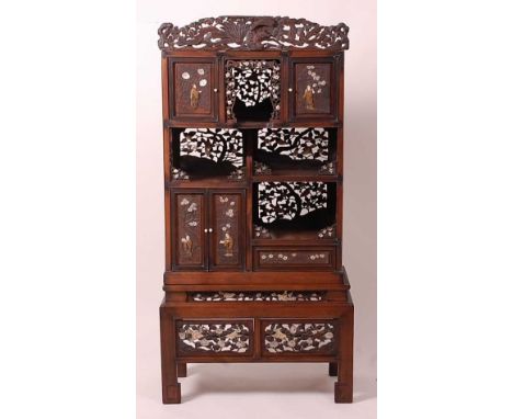 A Japanese Meiji period hardwood Shodana cabinet on stand, arranged as various cupboards and open shelves, with fret carving,