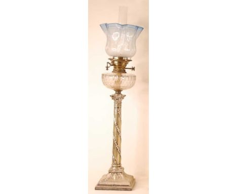 A late Victorian silver plated oil lamp, having an acid etched and blue tinted glass shade, cut clear glass font to a plated 