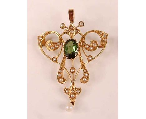 An Edwardian yellow metal, peridot and seed pearl set openwork pendant, comprising a centre oval faceted peridot within a scr