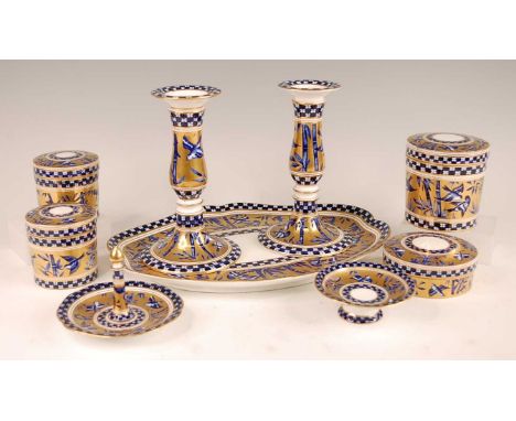 A late Victorian Coalport porcelain part dressing table set, comprising tray, pair of candlesticks, four jars and covers, rin