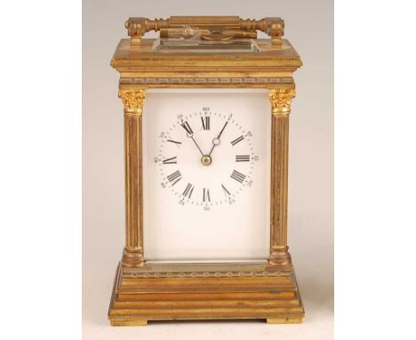 A circa 1900 French lacquered brass carriage clock, having an unsigned white enamel Roman and Arabic dial within fluted three