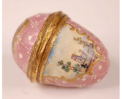 A late 18th century English enamel egg shaped bonbonniere, the pink ground decorated with three landscape vignettes within go