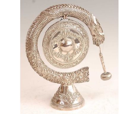 An Indonesian Yogya white metal pedestal table gong with hammer, as a boss shield chased with leaf and flowers within a serpe