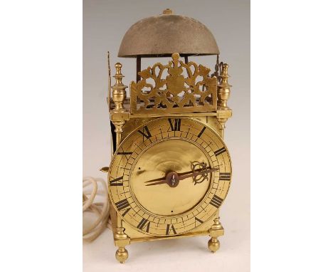 A Victorian brass lantern clock, having a fret-cut gallery over brass Roman chapter ring, single blue steel hand, thirty-hour