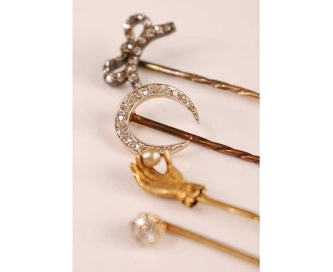 A yellow metal and diamond set stick pin, the old cut claw set diamond weighing approx 0.25 carats; together with a yellow me