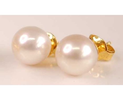 A pair of yellow metal and Japanese pearl ear studs, pearl dia. approx 9.5mm, stem unmarked but tests as approx 14ct, 3.1g