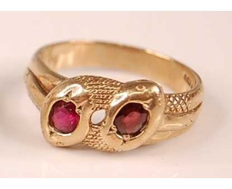 A 9ct yellow gold double-headed intertwining snake's head ring, each head set with an oval faceted garnet, garnet dimensions 