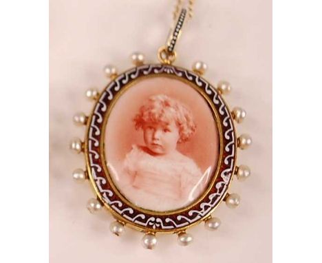 A late Victorian yellow metal oval memorial pendant, depicting a picture of a young girl within an enamel border surrounded b