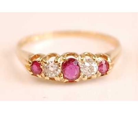 A yellow metal, ruby and diamond half hoop eternity ring, featuring three graduated oval rubies and two Old European cut diam