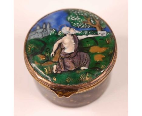 A gilt and enamel decorated circular pill box, having gilt metal hinged lid, the black ground decorated in deep blues, greens