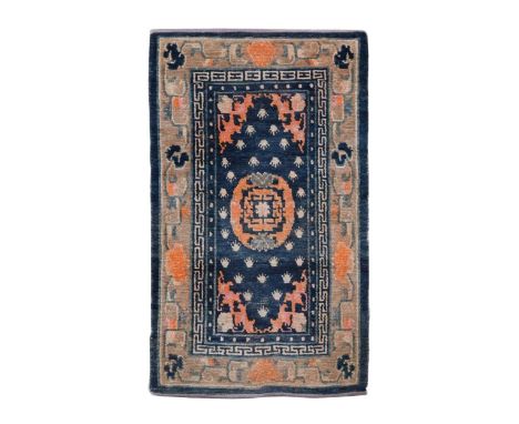 A Sino-Tibetan Shugden with single mandala, on indigo ground with flaming pearl spandrels in double key and floral cloud bord