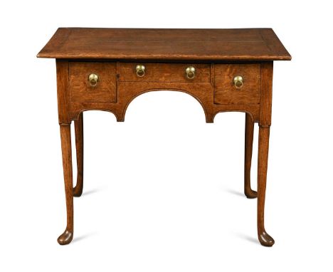 An oak low boy, 19th century, the rectangular top over three drawers raised on tapered legs and pad feet 67.5 x 82 x 56.5cmSt