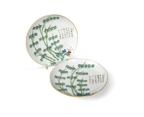 A pair of Chinese porcelain saucers, Qing Dynasty, 19th century, each painted with tall bamboo issuing from rocks, with calli