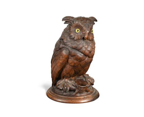A Black Forest carved wood tobacco jar, late 19th or early 20th century, naturalistically modelled as an owl, hinged at the n