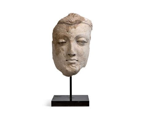 A Gandharan stucco fragmentary face of Buddha, North West India, 3rd/4th century, 25.5cm highThe Chinese Buddhist statuary an