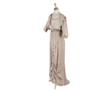 * Clothing. A silk Edwardian day dress, circa 1915, oyster silk full-length gown, with v-neck front and back filled with crea