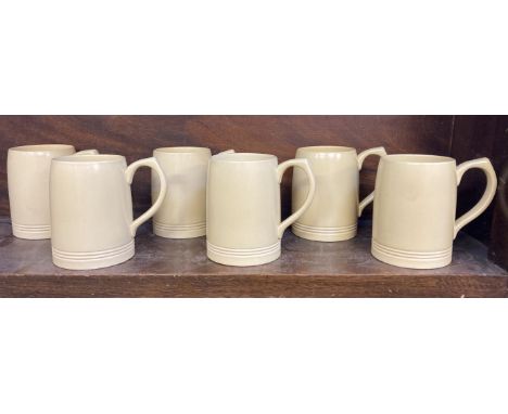 * Wedgwood. A matched set of six Wedgwood pottery mugs by Keith Murray, yellow / cream matt finish, blue marks to base, some 