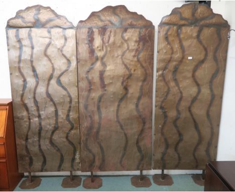 A lot of three 20th century steel free standing room dividers with hammered industrial design, each panel approximately 216cm