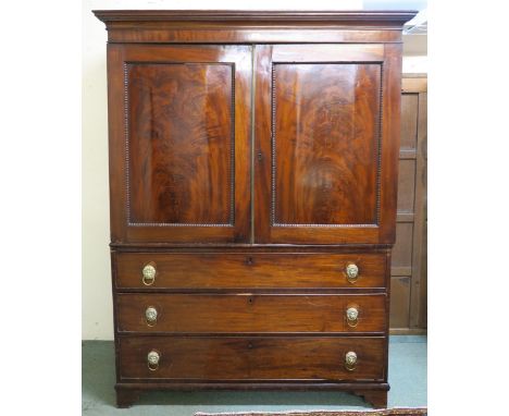 A Victorian mahogany linen press with moulded cornice over pair of panel doors (def) over three long drawers on bracket feet,