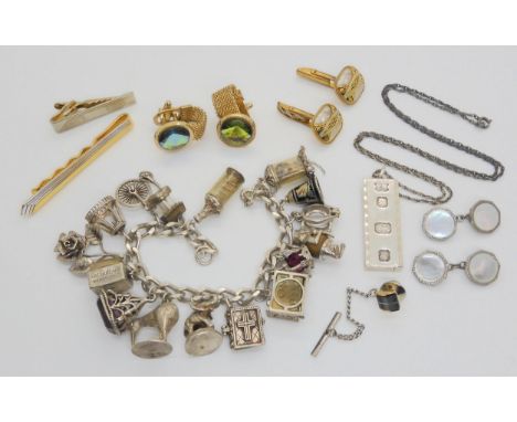 A silver charm bracelet, ingot pendant, and costume jewellery Condition Report:Not available for this lot.