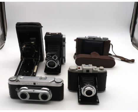 Various vintage cameras, including a Wirgin Stereo camera, a Moskva-5 medium format folding camera, a Voigtlander Bessa I fol