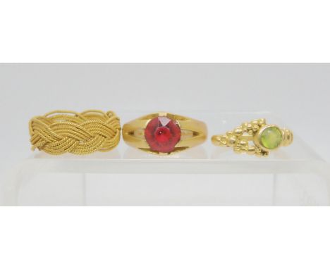 An red gem set ring, stamped 18c, size approx S, together with two bright yellow metal rings, weight together 14gms Condition