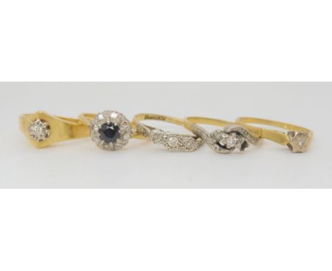 Four 18ct gold diamond rings, one is missing two stones, and a diamond and sapphire cluster ring, weight all together 15.1gms