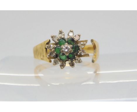 An 18ct emerald and diamond flower ring, (af) size M, weight 3.8gms Condition Report:Available upon request