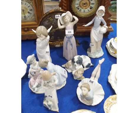 A collection of Lladro and Nao figures including a ballerina, puppies etc Condition Report:Available upon request