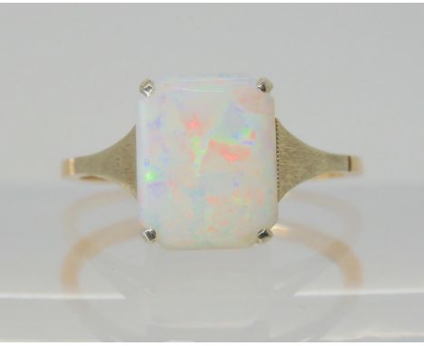 a vintage white opal ring, set with a 10mm x 8.2mm x 1.7mm solid white opal. With white gold shoulders the shank is stamped 9