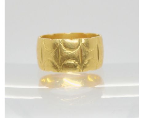 An 18ct gold retro wide wedding ring, size L1/2, weight 7gms Condition Report:Available upon request