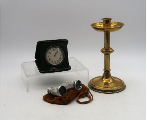 An early-C20th travelling clock with eight-day Swiss movement and radium-painted Arabic numerals, the case of forest green le
