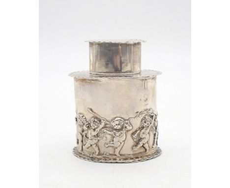 An Edwardian silver tea caddy, of oval form, with cast decoration of cherubs frolicking amongst vines, with crimped rims, by 