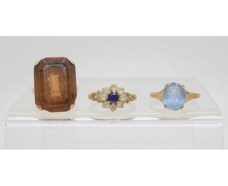 Three 9ct gem set rings, smoky quartz style, size L, blue gem, size O, blue and clear flower ring size K, weight together 10.