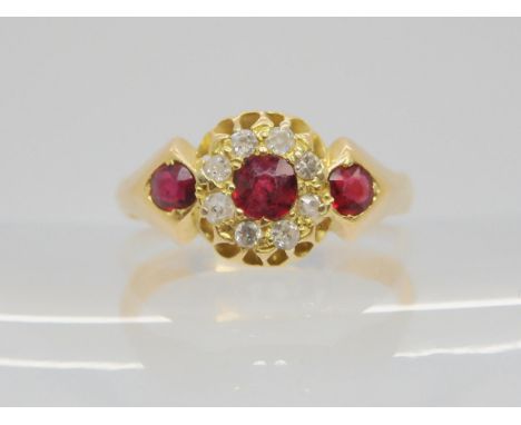 An 18ct gold ruby and diamond flower ring, size Q1/2, weight 4.3gms Condition Report:Available upon request