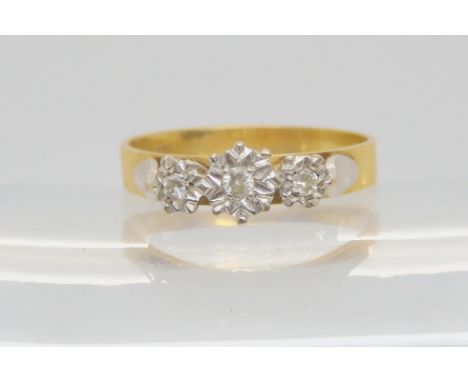 An 18ct gold illusion set diamond three stone ring, size V1/2, weight 4.5gms Condition Report:Available upon request