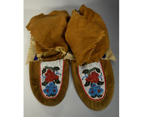 Tribal Art - a pair of Native American moccasins, brightly decorated in beadwork with stylized flowers, 25cm long