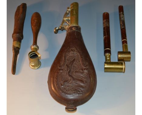 A 19th century leather tear-drop powder flask, embossed with game birds and foliage, within a C and S-scroll frame, gilt bras