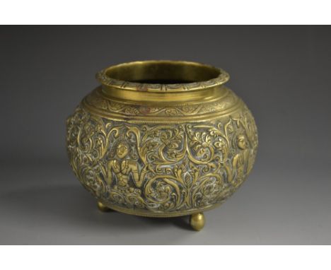 A 19th century Indian bronze censer, cast in relief with deities amongst scrolling leafy branches, ball feet, 12cm wide 
