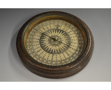 A '19th century' oak circular table top compass, 12.5cm paper register, baize-lined base, 17cm diam 