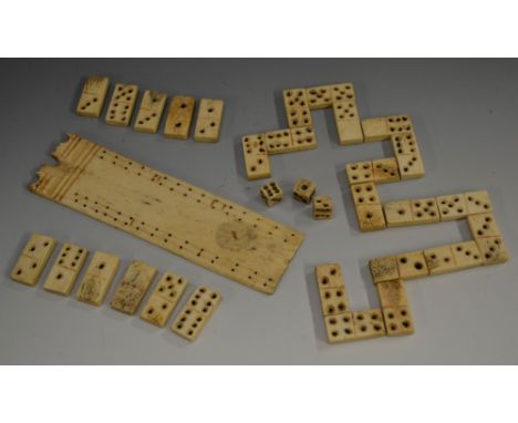 A Napoleonic prisoner of war bone cribbage board, 14cm long, early 19th century; a set of dominoes, similar; dice (qty)