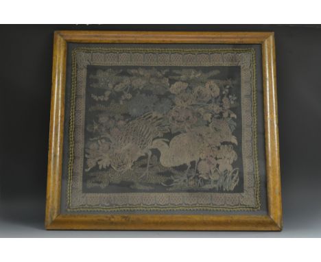 A Chinese rectangular needlework panel, embroidered in coloured threads with a pair of pheasants, peonies and blossoming foli