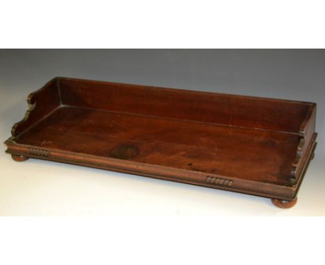 A William IV mahogany rectangular book trough, shaped three-quarter gallery, bun feet, 60cm wide, c.1835   Condition Report: 