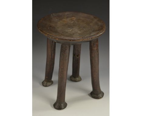 Tribal Art - an African hardwood stool, dished circular top, slightly outswept legs, pad feet, 28cm high, 22cm diam, 19th/ear