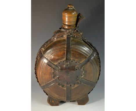 A 19th century Scandinavian leather bound treen water flask or canteen, domed cover, shaped and pierced strap borders and bos